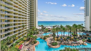 A hotel with multiple floors, a large pool area with multiple pools, and a beach view. - Shores Of Panama 618 2 Bedroom Condo (Panama City Beach)