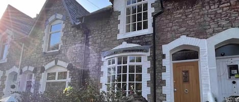 Classic architecture with a prominent bay window and traditional front door.