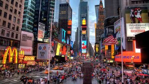 A busy urban street scene with tall buildings, bright billboards, and a crowd of people. - WORLD CUP + minutes to NYC (Union City)