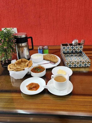 A tray with a variety of dishes including flatbread, soup, and a cup of tea. - Airport Hotel Park Blue (New Delhi)