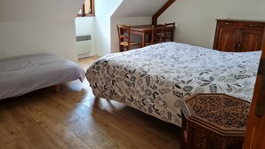 A bedroom with a bed, a chair, a wooden cabinet, and a window. - La Parenthèse Verte, Guesthouse & Panorama (Mont-Saint-Jean)