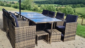 An outdoor dining area with wicker furniture and a large umbrella. - La Parenthèse Verte, Guesthouse & Panorama (Mont-Saint-Jean)
