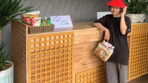 Una mesa de recepción con mostrador de registro, una cesta de aperitivos y un cartel con un nombre.