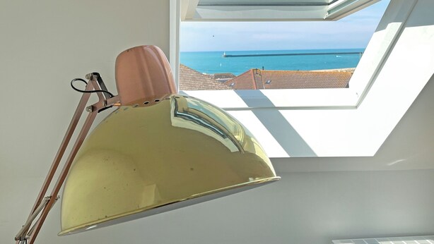 A skylight with a view of the sea and buildings. - 2 bedroom accommodation in Seaford (Seaford)