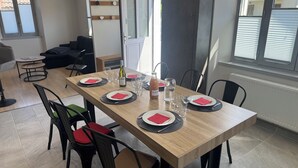 A dining area with a wooden table set for four, including plates, cutlery, and glasses. - "LA SAUFFAZ - Your vacation in Savoie with family or friends (Faverges)