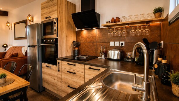 A modern kitchen with a built-in oven, microwave, and stainless steel sink.