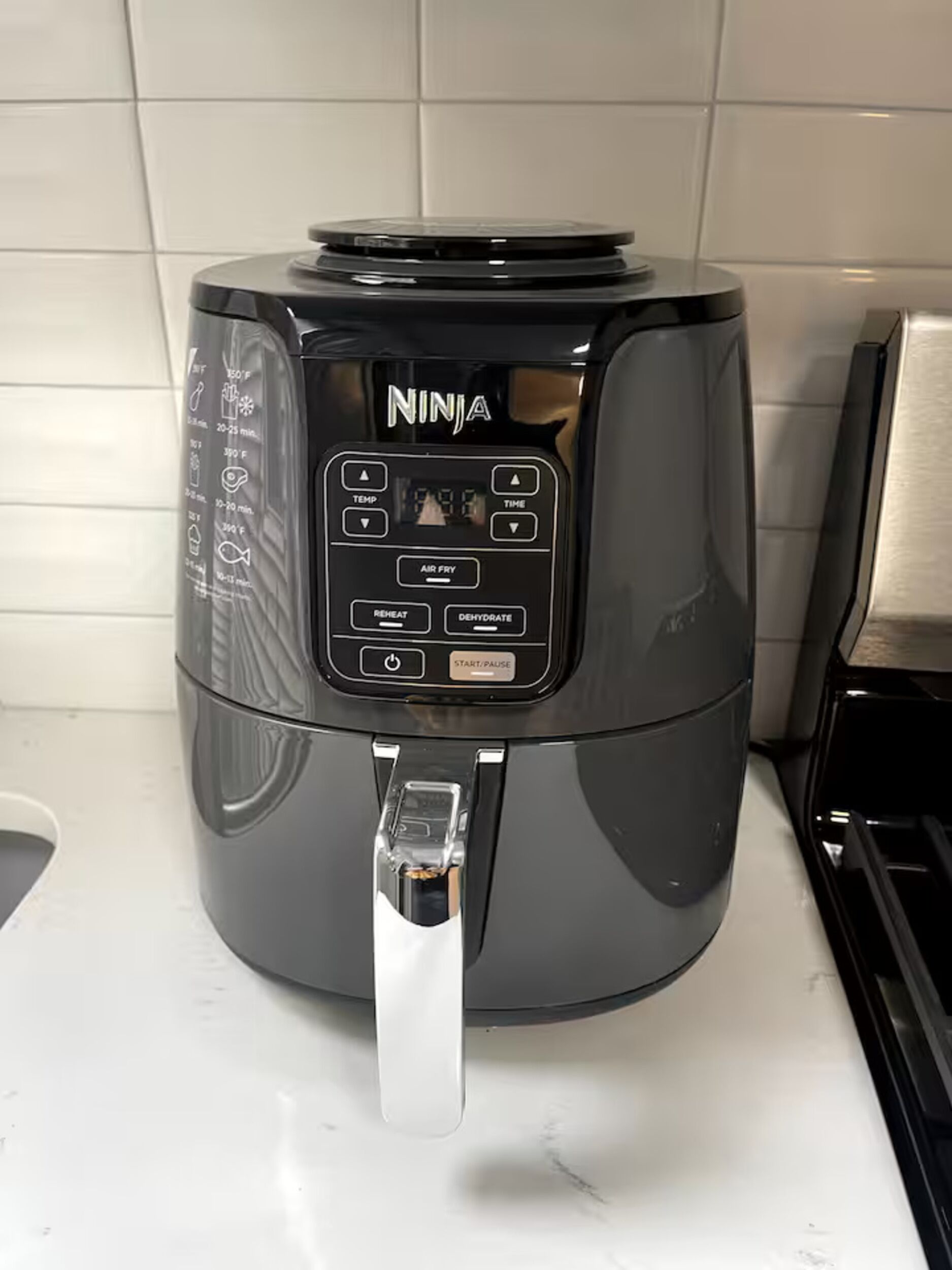 A kitchen with a Ninja air fryer on the counter.