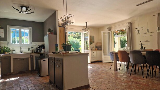 A spacious kitchen with a central island, a dining area with chairs, and a large window providing natural light. - Quiet country house, swimming pool, ideal for families - Aix en Provence (Aix-en-Provence)