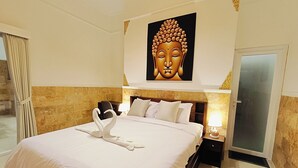 A hotel room with a large bed, a Buddha painting above the bed, and a swan-shaped towel arrangement. - 2BR Pool Villa-Twin Flower (Banjar)