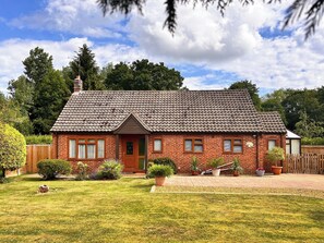 A two-story brick house with a tiled roof, a front porch, and a well-maintained lawn. - 2 bedroom accommodation in Smallburgh (Smallburgh)