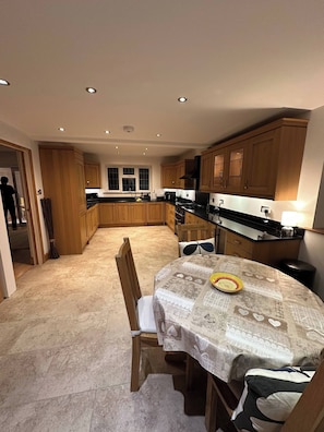 Enjoy meals in the kitchen with a central island and dining table.