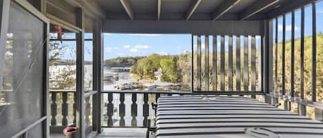 Enjoy breathtaking views of the water and surrounding landscape from this room's expansive balcony.