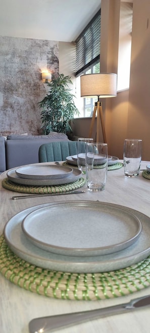 A dining table set with plates, glasses, and a lamp. - 2 Bed Apartment in Brighton centre | Sleeps 6 (Brighton and Hove)