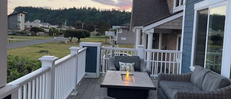 Relax on the deck with a view of the surrounding neighborhood and forested hill.