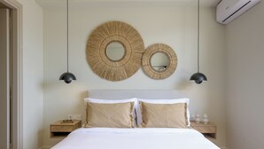 A bedroom with a large bed, two bedside tables, and two wall-mounted mirrors. - Acropolis Dream with Plunge Pool (Athina)