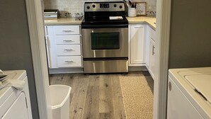 A kitchen with white cabinets, a stainless steel stove, a microwave, and a dishwasher. - Relaxation, Comfort & Style (Lawton)