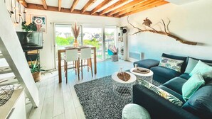 Una sala de estar moderna con sofá, mesa de centro y comedor.