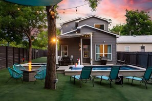 A backyard with a swimming pool, outdoor seating, and a covered patio area. - Downtown Austin Oasis Pool & Hot Tub (Austin)