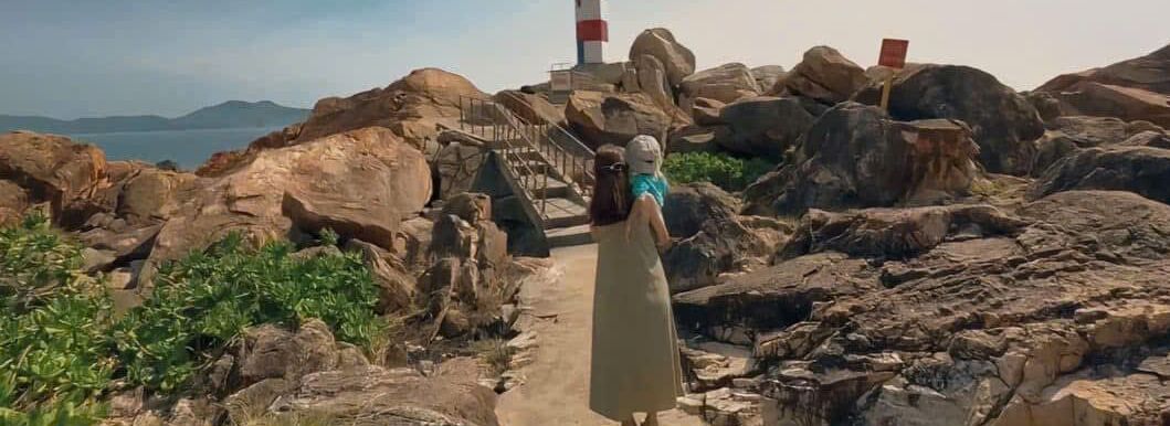 A rocky path leading to a lighthouse.