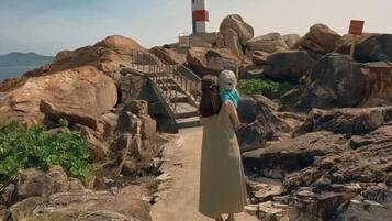 A rocky path leading to a lighthouse.