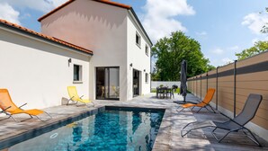 A modern house with a swimming pool, outdoor seating, and a patio area. - Le Pré Tarin by Interhome (La Bernerie-en Retz)
