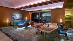 A modern hotel room with a large window, a sofa, a dining table with chairs, and a painting on the wall. - Xi'an The Muslim Quarter Manxin Hotel (Xi'an)