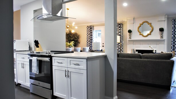 A modern kitchen with white cabinetry, a built-in oven, and a central island. - Charming 3-bedroom ranch home, back deck, close to ATL, in peaceful Norcross (Norcross)