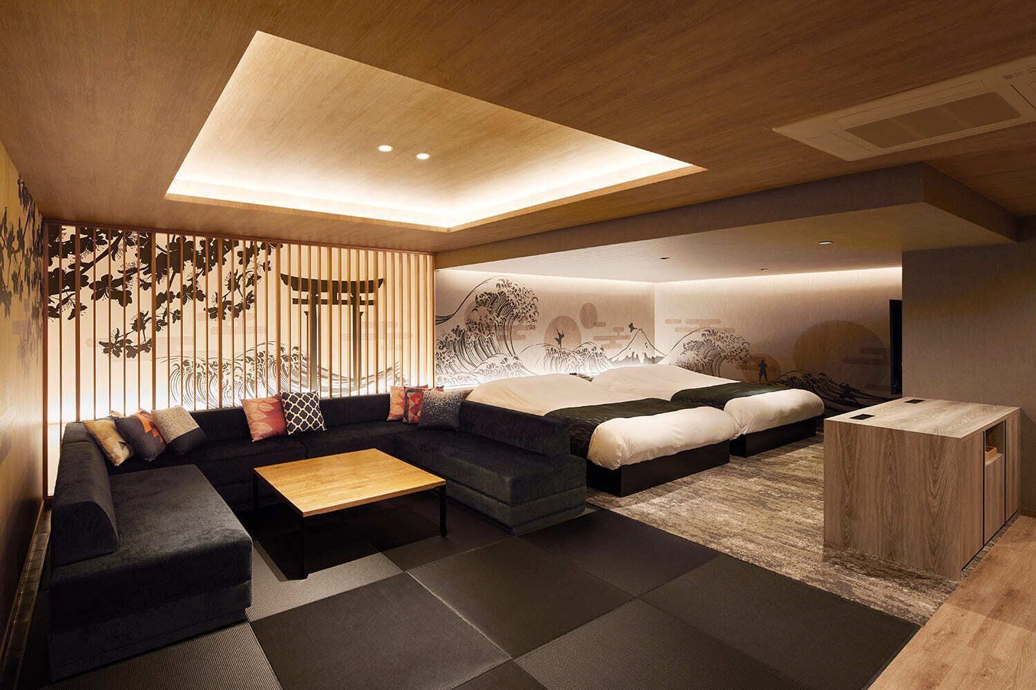 A modern living room with a sofa, coffee table, and a bed with a headboard.