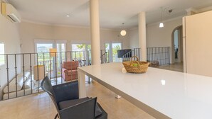 A spacious living area with a long white table, a wicker basket, and a view of the outdoors. - Awesome home in Orba with WiFi (Orba)