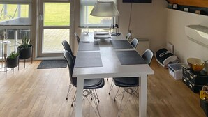 A modern kitchen with a dining table, chairs, and a large window. - Awesome home in Samsø with WiFi (Samsø)
