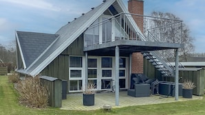 A modern house with a sloped roof, a balcony, and a chimney. - Awesome home in Samsø with WiFi (Samsø)