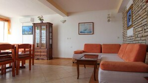 A living room with a sofa, chairs, a cabinet, and a tiled floor. - Two bedroom amazing apartment in Milna (Milna)