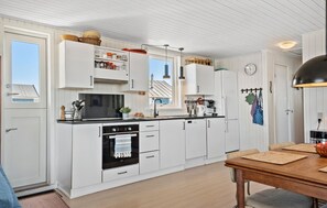 Fridge, stovetop, dishwasher, coffee/tea maker