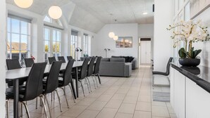 A modern kitchen with a dining area, large windows, and a view of the outside. - Pet friendly home in Ulfborg with sauna (Ulfborg)