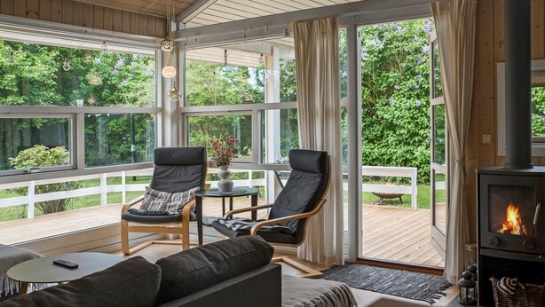 A cozy room with a fireplace, two chairs, a sofa, and a table. - Nice home in Grevinge with WiFi (Grevinge)