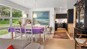 A modern interior with a dining area, kitchen, and seating space. - Amazing home in Roslev with WiFi (Roslev)