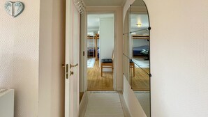 A hallway leading to a bedroom with bunk beds, a wooden chair, and a small rug. - 1 bedroom gorgeous home in åsa (Åsa)