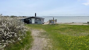 A small building with a gravel path leading to a dock by a lake. - 1 bedroom gorgeous home in åsa (Åsa)
