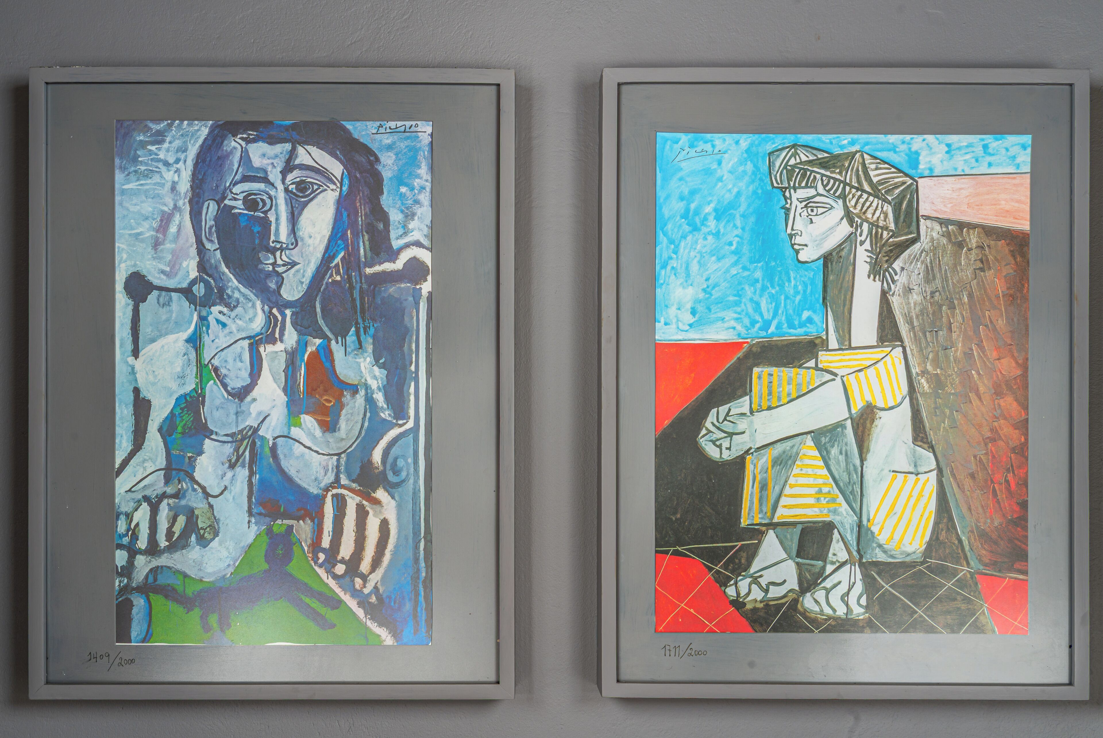 Two framed artworks on a wall.