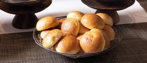 A buffet table with three bowls of baked goods.