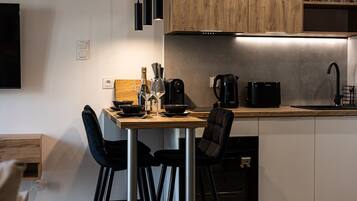 Elegant evening setup with wine glasses and balcony access, overlooking central Bydgoszcz, just minutes from Opera Nova and Mill Island.