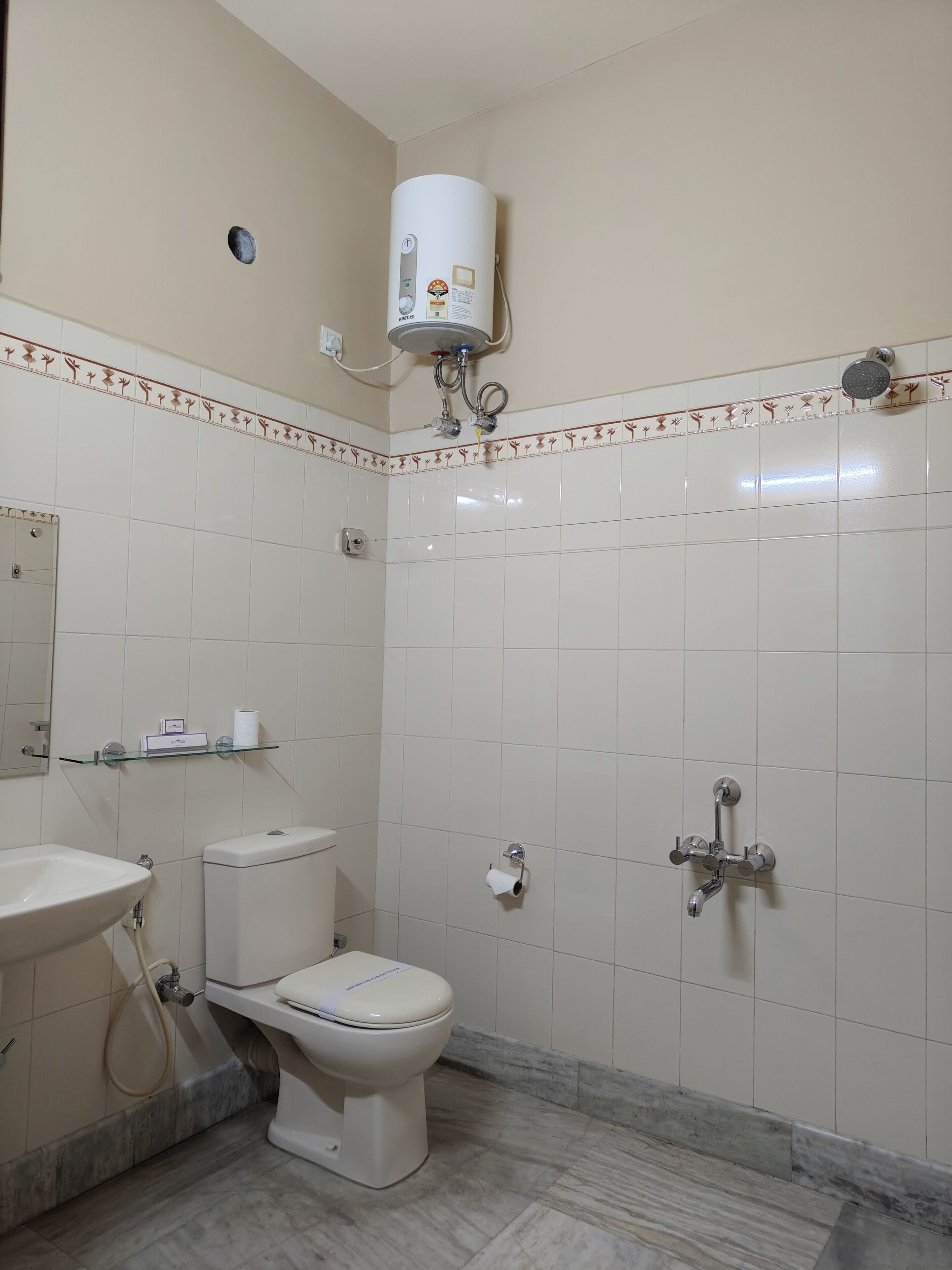 A bathroom with a toilet, sink, and shower.