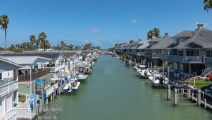 A canal lined with waterfront houses and boats. - Long Island Village Pet Friendly 857 (Port Isabel)