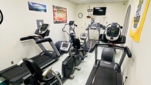 A gym with treadmills, elliptical machines, and stationary bikes. - 307 Long Island Village (Port Isabel)