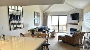 A spacious living area with a kitchen island, a dining table, and a seating area with a sofa and chairs. - Expansive Views-2/2.5 Premier Unit Seascape Resort (Aptos)