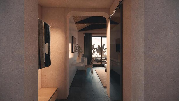 Un couloir étroit avec un banc, un luminaire fixé au mur et une porte donnant sur une pièce avec vue sur l’extérieur.