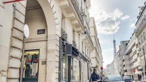 A street view with a boutique store named "Passage Jean-Nicolas" and a cafe called "The Kooples."