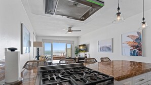 A modern kitchen with a gas stove, granite countertops, and a view to the beach. - Private beach, toes on the Sand!  Waterworld! STR23-0121 (Dana Point)