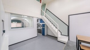 A multi-level interior with a staircase, a kitchen area, and a dining table. - Gyeongju Nollowa Spa Pension (Gyeongju)