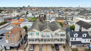 A residential area with multiple two-story houses, some with balconies, and a clear view of the surrounding neighborhood. - Modern 3 Bedroom Condo in a Prime Location (Wildwood)